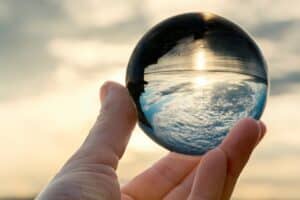 Sky in crystal ball in hand